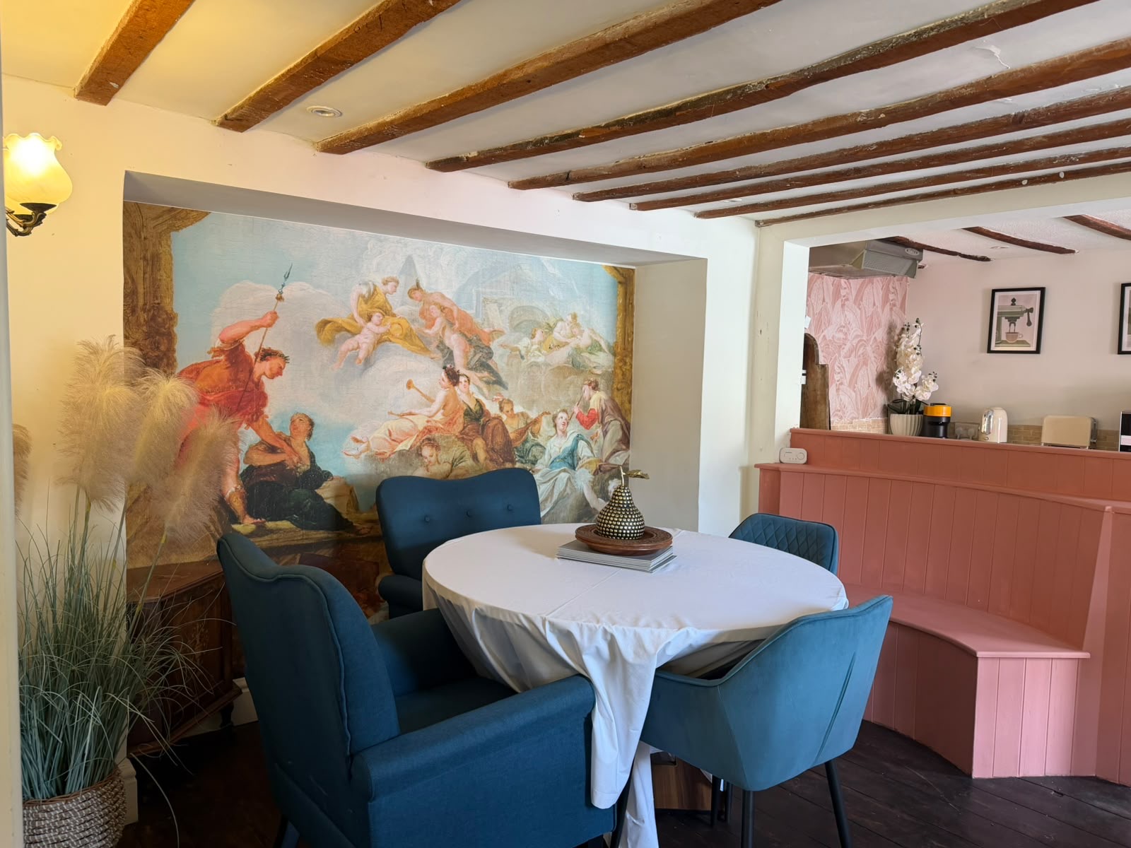 Beamed dining room with an antique painted mural