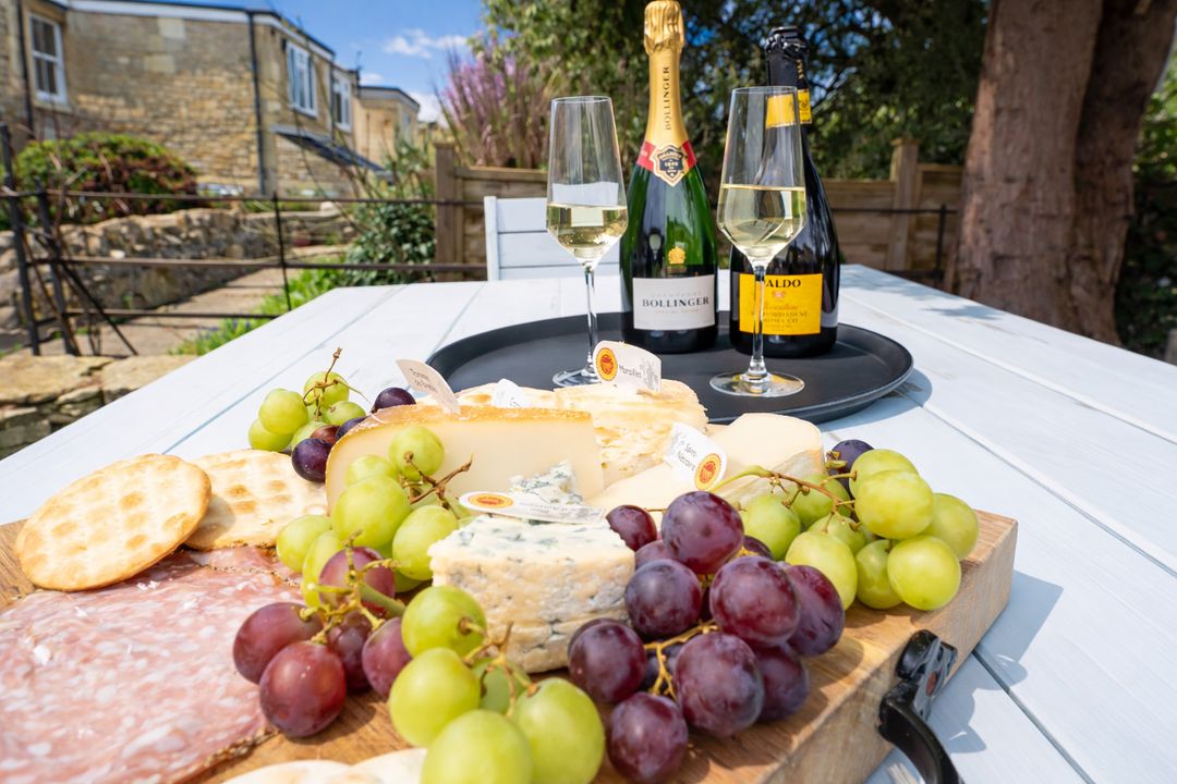 Cheese board and sparkling wine served in the garden