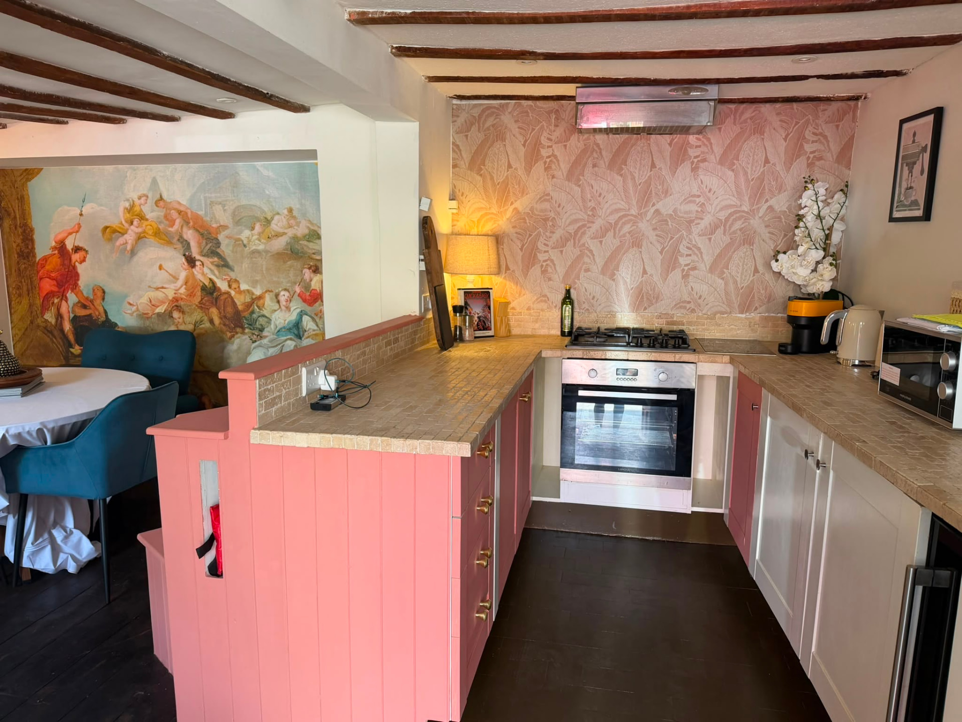 Pink cottage kitchen with beamed ceiling