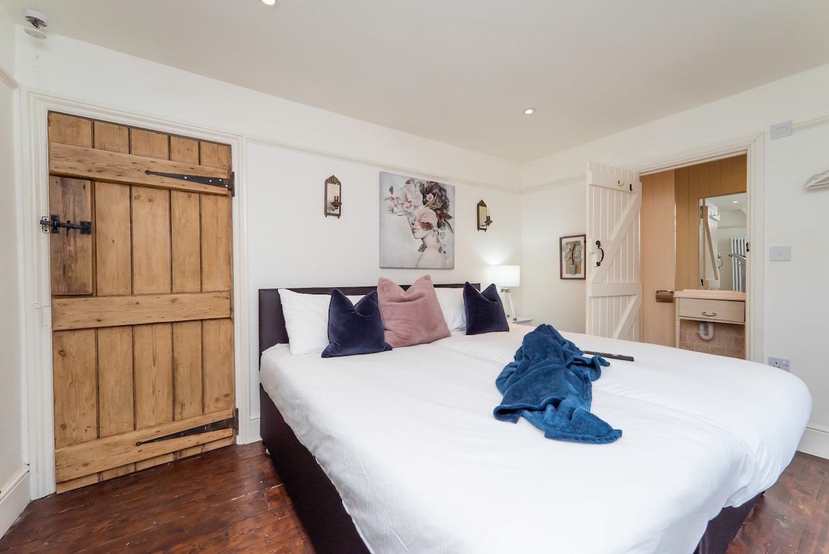 Cottage bedroom with a super king bed and an original plank door