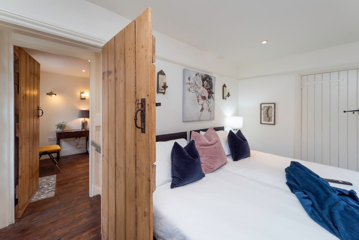 Cottage bedroom looking through to an adjoining room